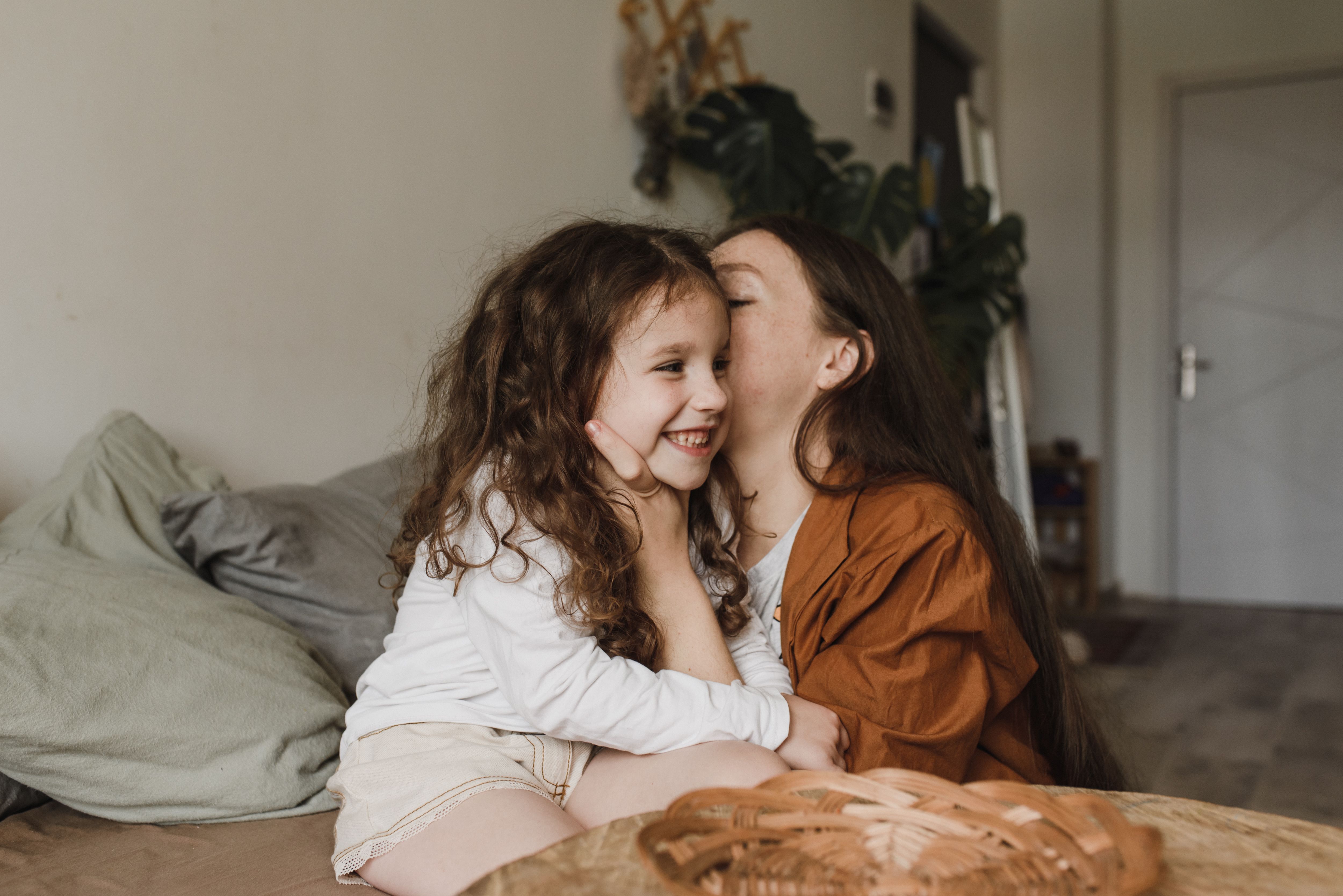 emotionally intelligent child shown through a parent kneeling and gently talking to an upset young child